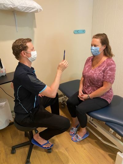 A therapist assessing balance after a concussion