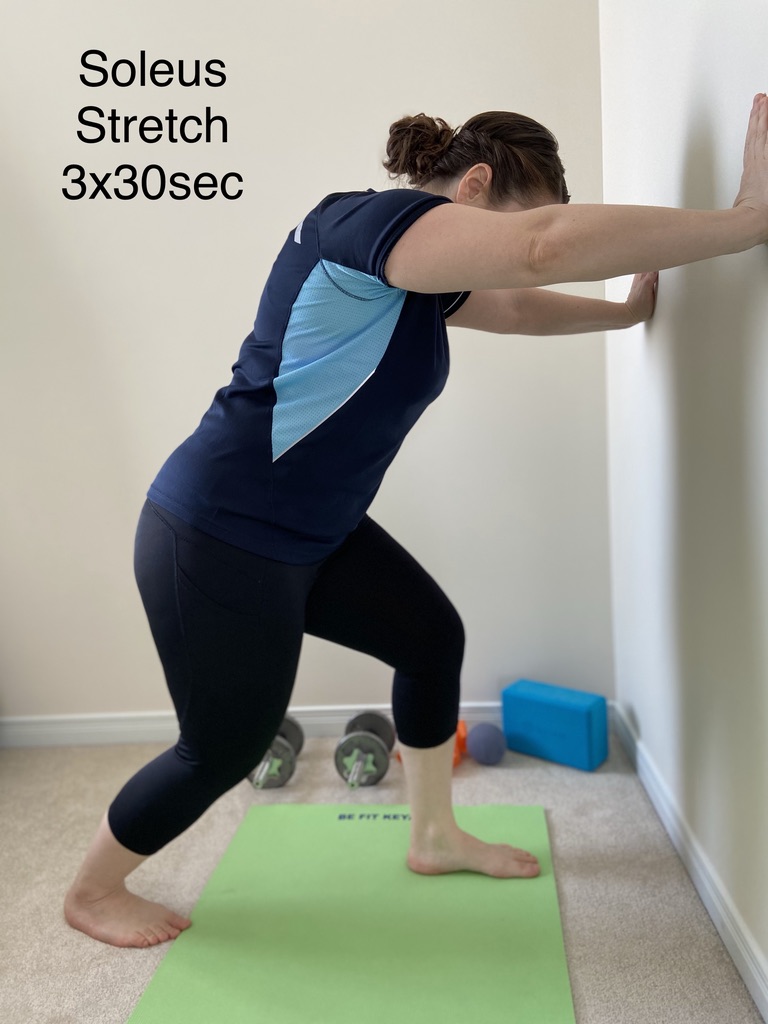 Soleus stretch against a wall, three sets of thirty seconds