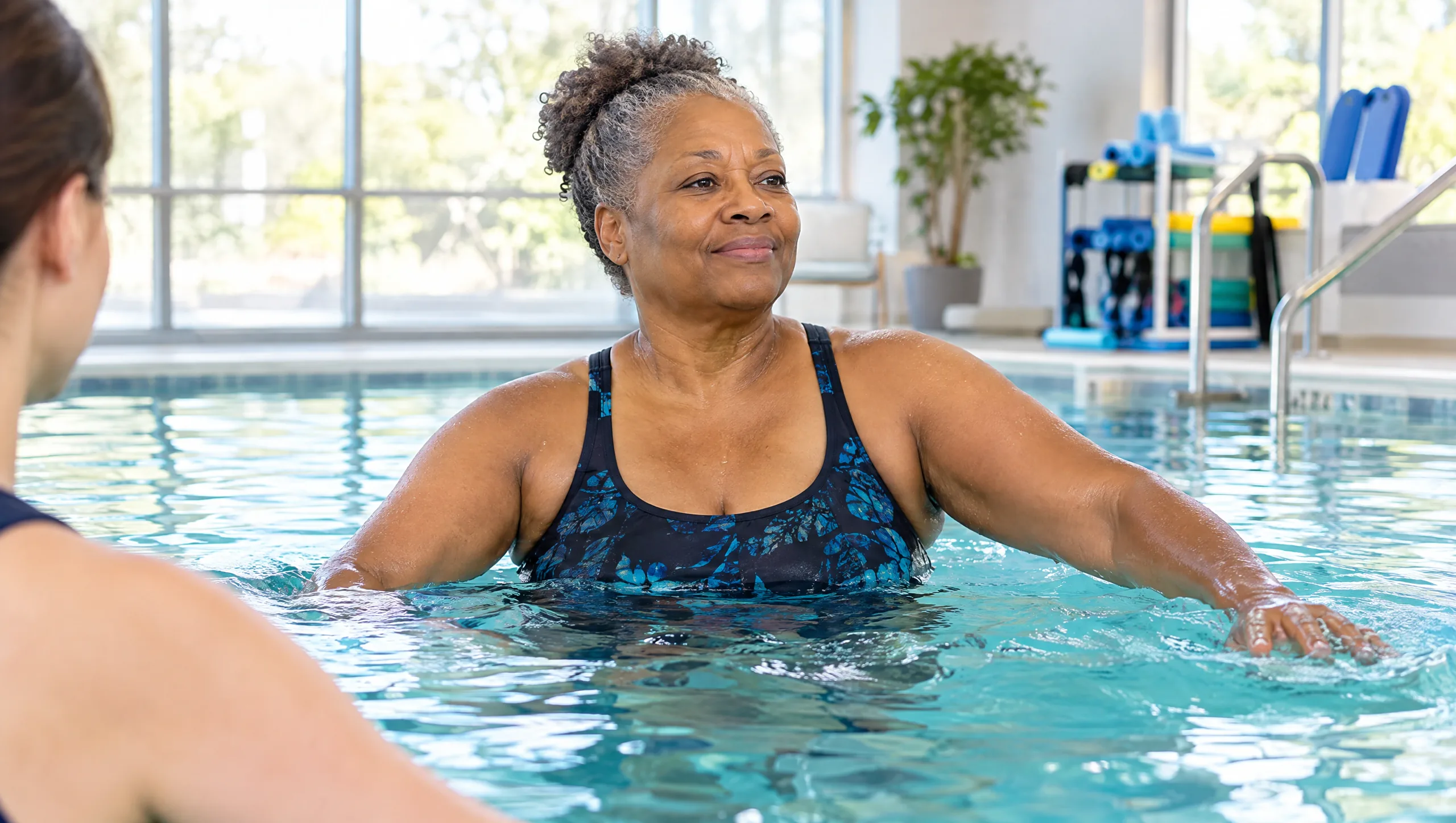 A patient doing guided water exercise in the therapy pool