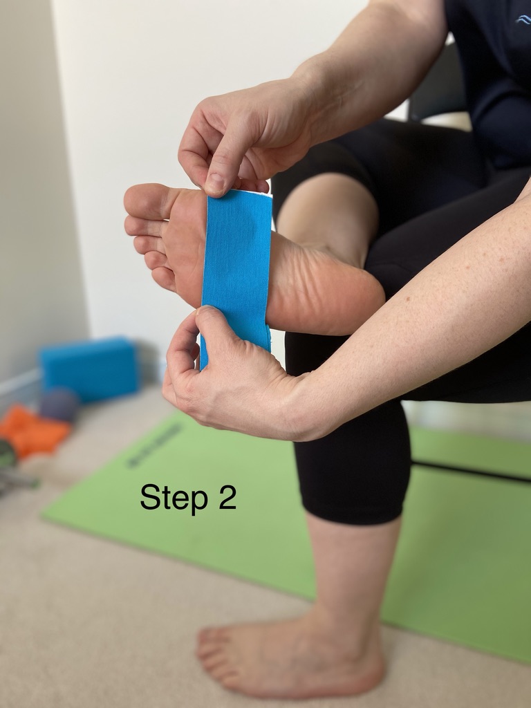 Cutting two shorter strips of kinesiology tape