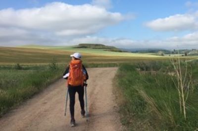 Walking with poles on a gravel trail in open countryside