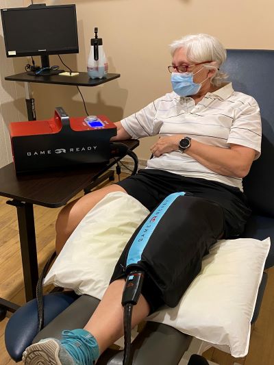 A patient using the Game Ready wrap while seated