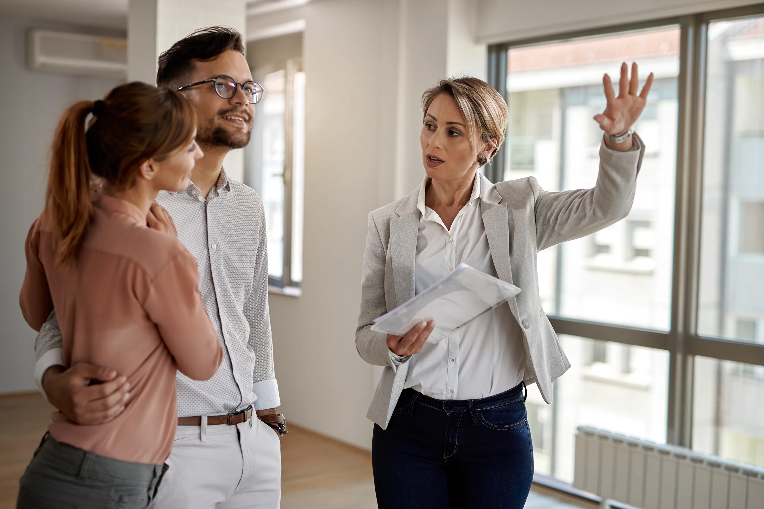 Young couple meeting with a real estate agent while buying their new home