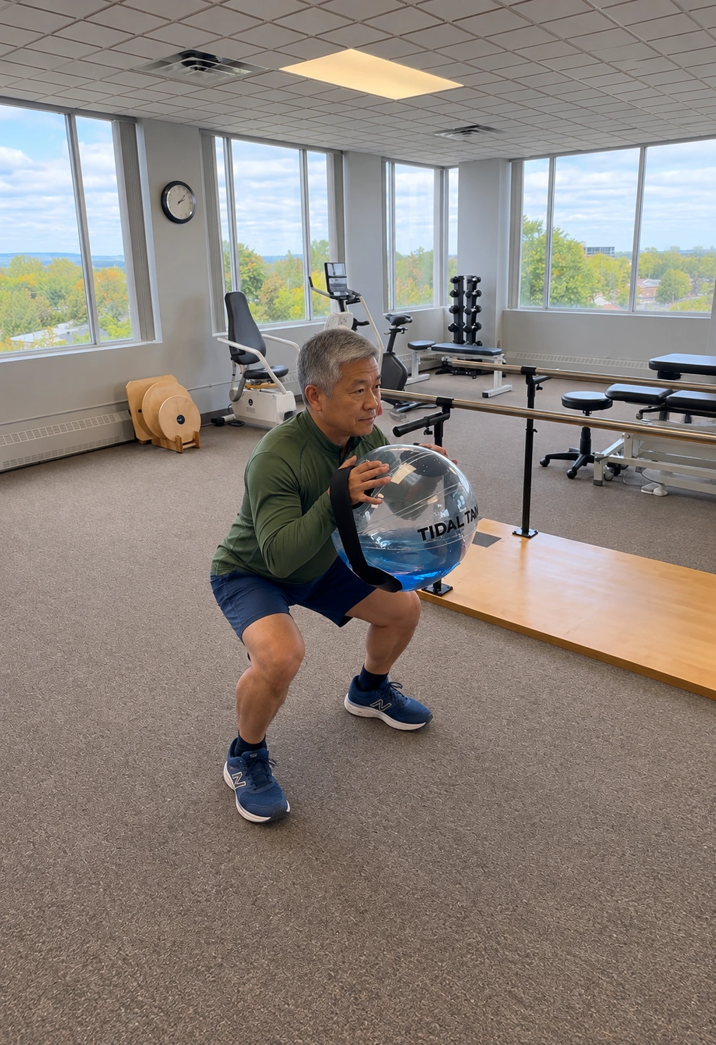 A veteran doing a land-based squat exercise with a weighted ball