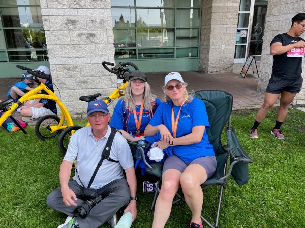 Supporters seated on the grass beside the course