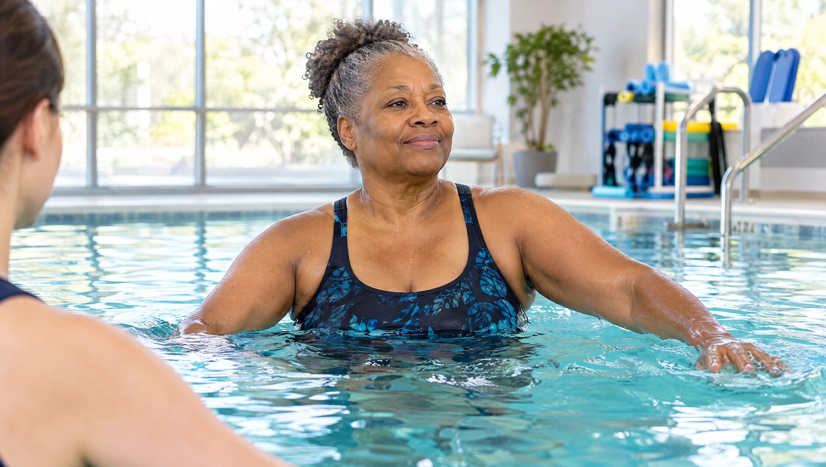 A patient doing guided water exercise in the therapy pool