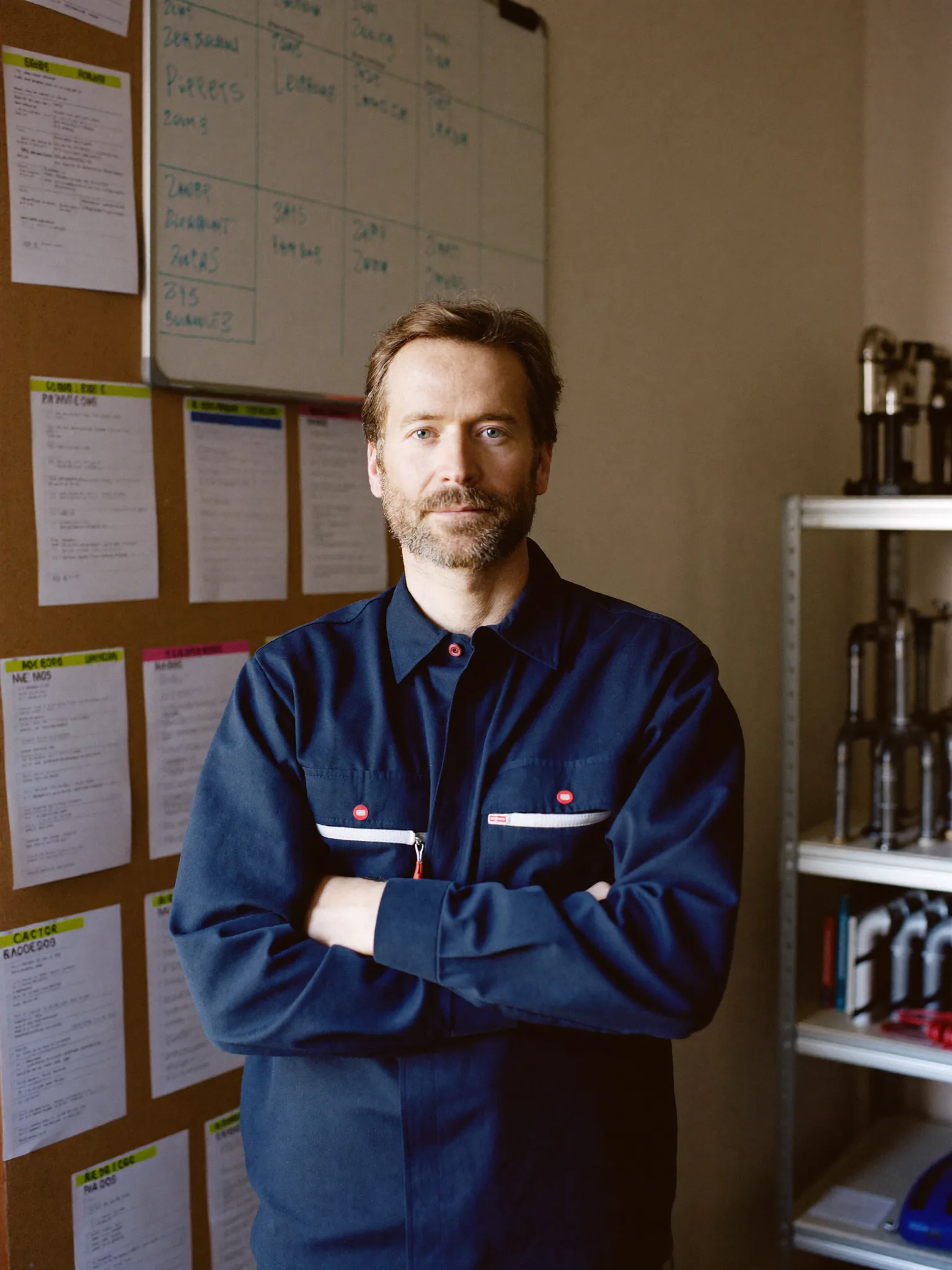 A plumbing company owner standing in his back office