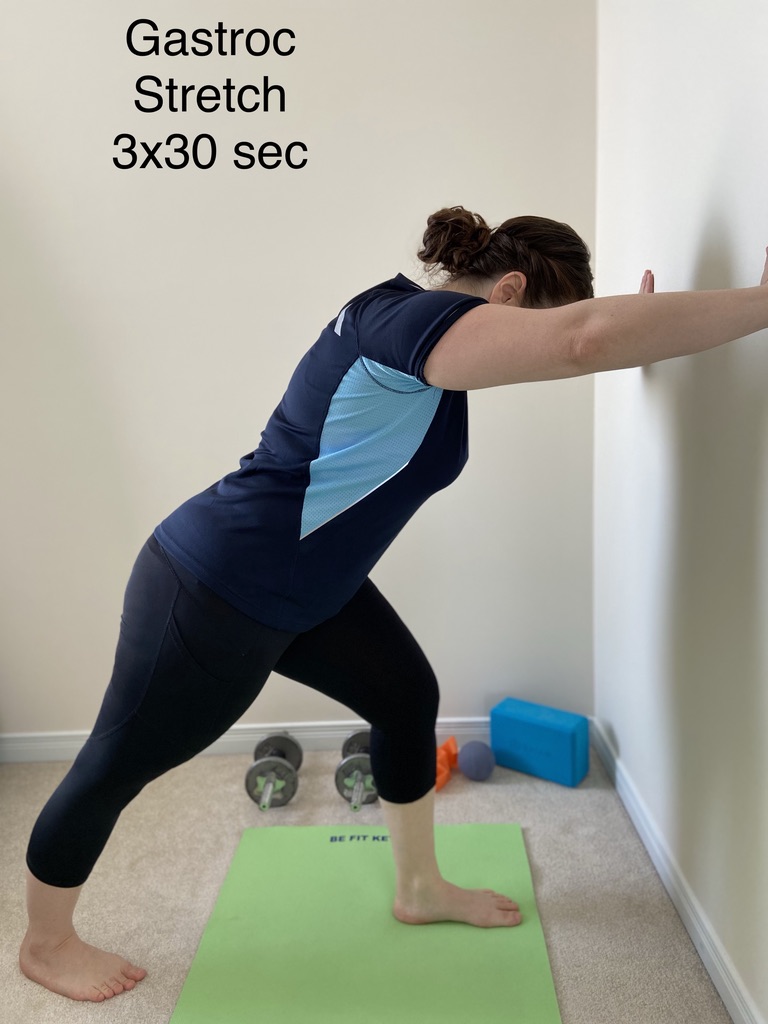 Gastrocnemius stretch against a wall, three sets of thirty seconds