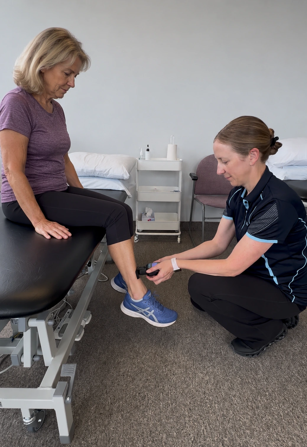 A physiotherapist working with a patient at the treatment bed