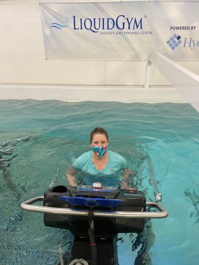 A patient working with a therapist in the therapy pool
