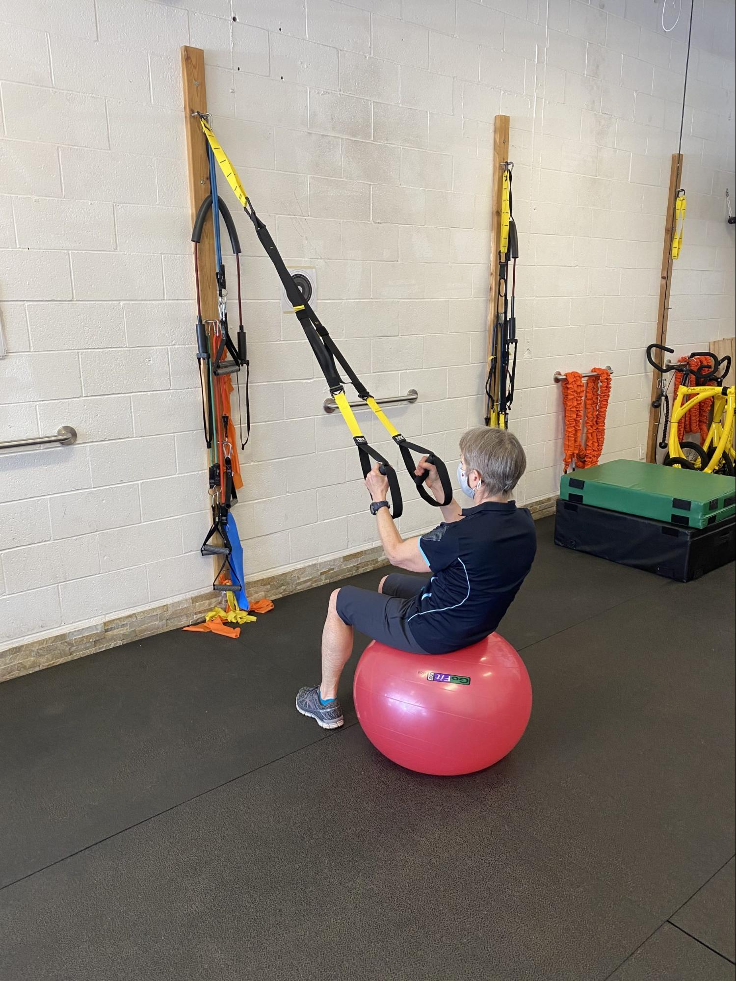 Using a stability ball as a seat for upper body work