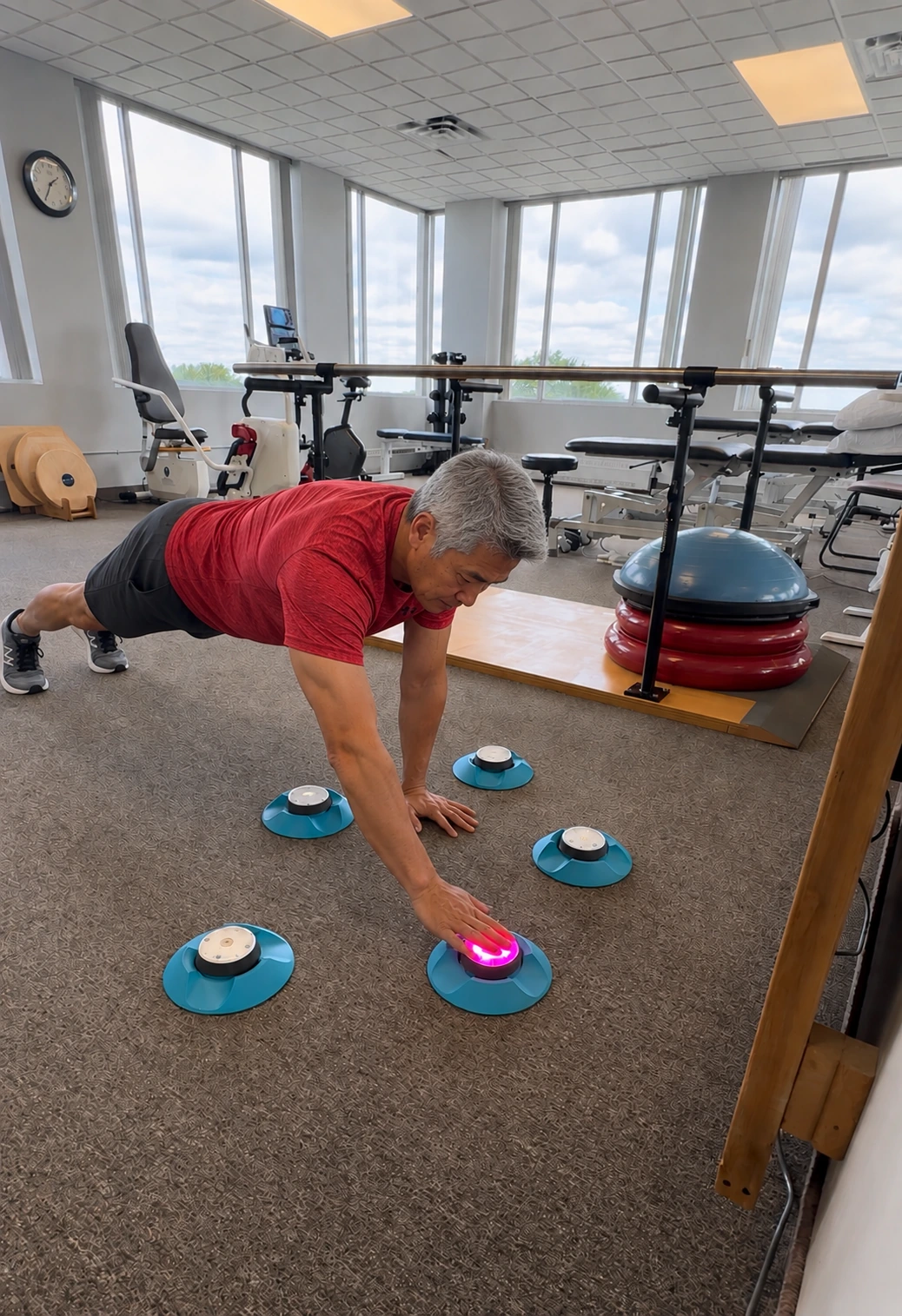 A client doing a reaction and core exercise on land at the LiquidGym clinic