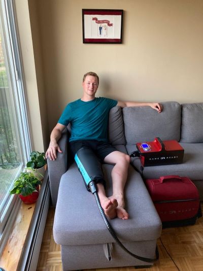 The portable Game Ready system set up beside a sofa